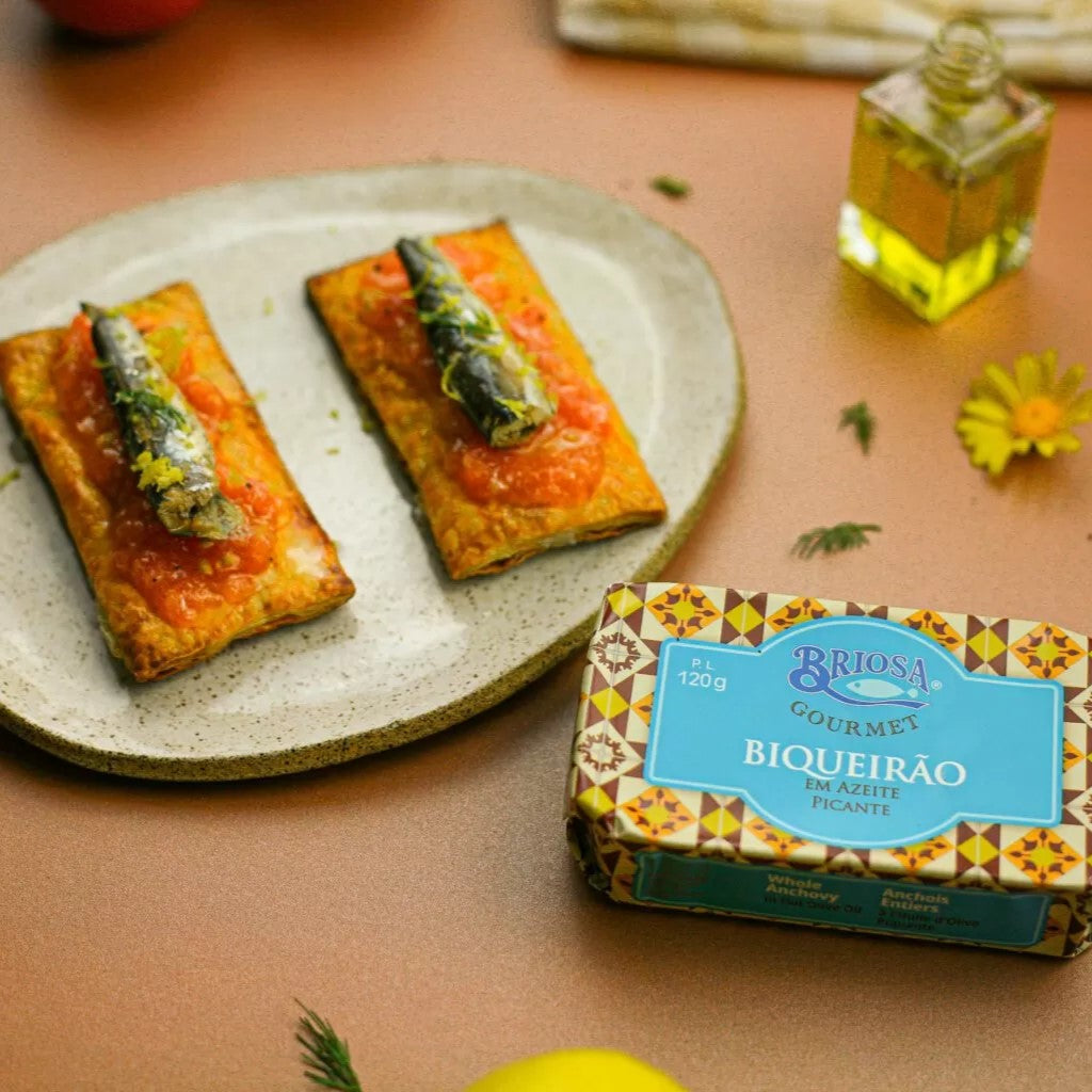 Whole Anchovies in Spicy Olive Oil by Briosa Gourmet served on crispy crackers with tomato spread